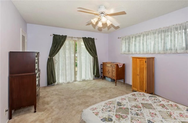 bedroom with light carpet and a ceiling fan