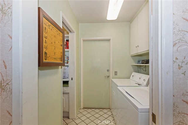 laundry room featuring cabinet space, washer and clothes dryer, and light tile patterned floors