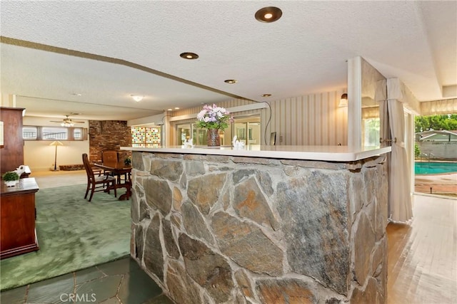 bar featuring a textured ceiling and carpet floors