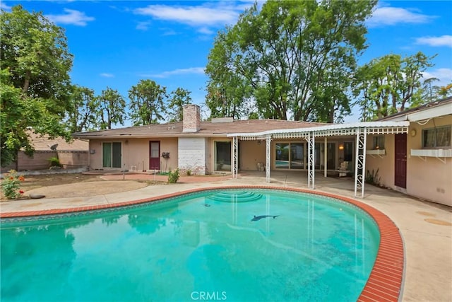 swimming pool with a patio and fence