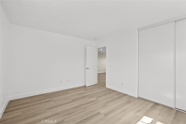 2455 Delicious Ln, Palmdale, CA 93551 - unfurnished bedroom featuring light wood finished floors, baseboards, a closet, and recessed lighting