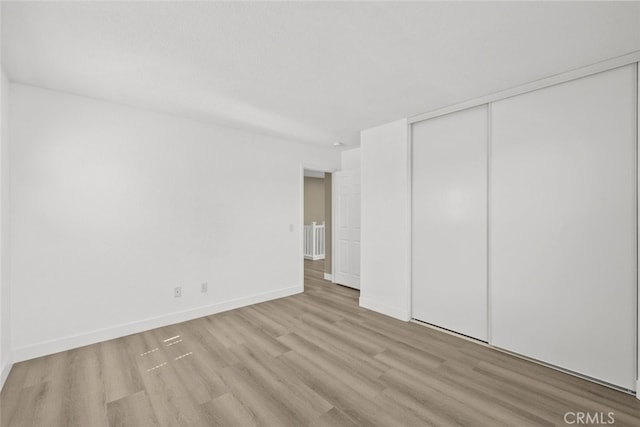 2455 Delicious Ln, Palmdale, CA 93551 - unfurnished bedroom with wood finished floors, a closet, and baseboards