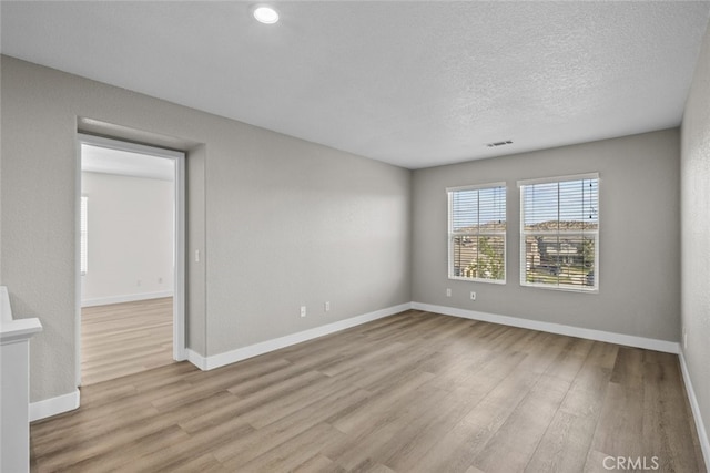 2455 Delicious Ln, Palmdale, CA 93551 - unfurnished room featuring wood finished floors, baseboards, and a textured ceiling