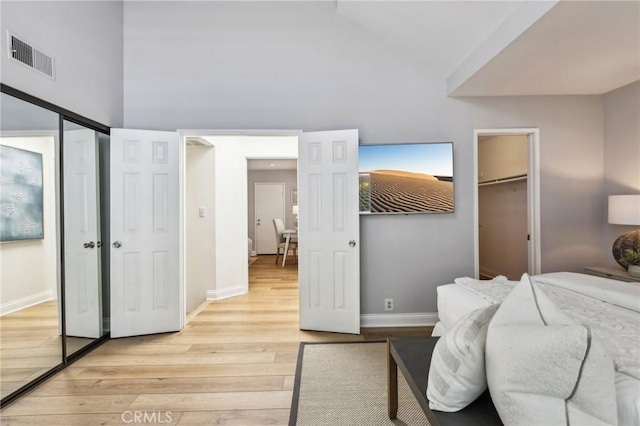 1304 12th St Unit B, Manhattan Beach, CA 90266 - bedroom featuring light wood-style flooring, baseboards, high vaulted ceiling, and a closet