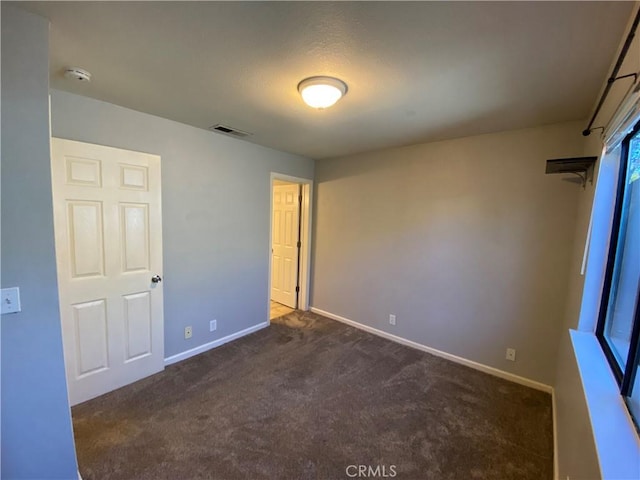 1114 Nord Ave Unit 11, Chico, CA 95926 - unfurnished bedroom with dark carpet and baseboards