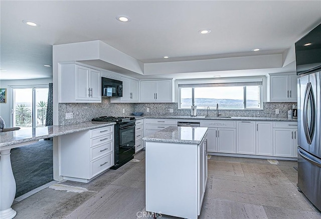 425 Calle Cielo, Nipomo, CA 93444 - kitchen featuring black appliances, a sink, backsplash, light stone counters, and white cabinets