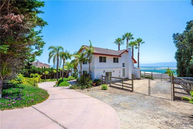 425 Calle Cielo, Nipomo, CA 93444 - view of front of house with a gate, stucco siding, fence, a tiled roof, and a water view