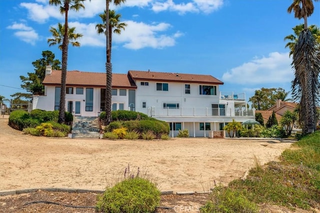 425 Calle Cielo, Nipomo, CA 93444 - rear view of house with a chimney, a balcony, and stucco siding