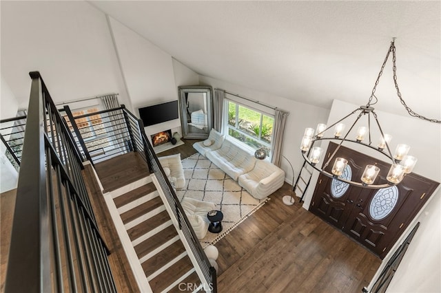 24772 Eldamar Ave, Lake Forest, CA 92630 - living room featuring a chandelier, vaulted ceiling, and dark wood-style floors