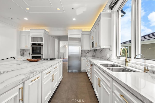 530 Kings Rd, Newport Beach, CA 92663 - kitchen with stainless steel appliances, decorative backsplash, a sink, recessed lighting, and light stone countertops
