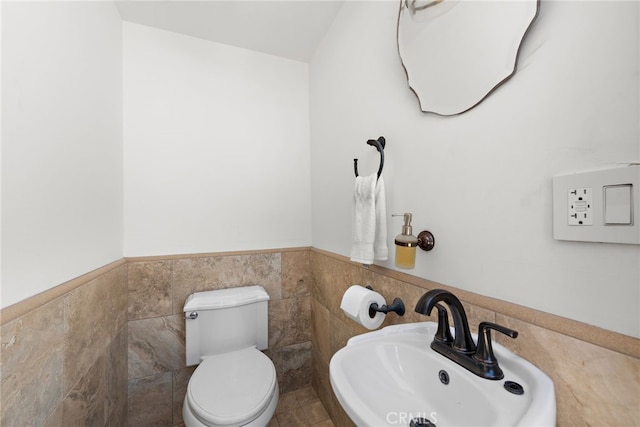 530 Kings Rd, Newport Beach, CA 92663 - half bath with a sink, a wainscoted wall, toilet, and tile walls