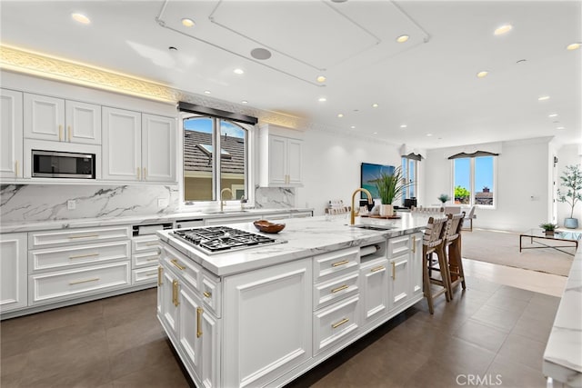 530 Kings Rd, Newport Beach, CA 92663 - kitchen featuring stainless steel appliances, a sink, recessed lighting, a center island with sink, and decorative backsplash
