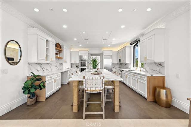 530 Kings Rd, Newport Beach, CA 92663 - kitchen with stainless steel appliances, recessed lighting, open shelves, white cabinets, and light stone countertops