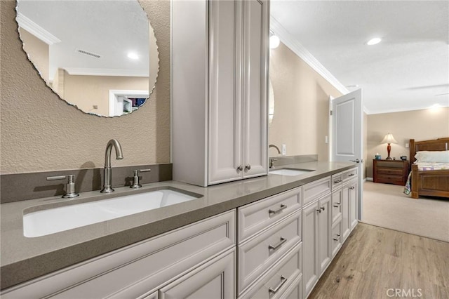1412 Alta Mesa Way, Brea, CA 92821 - ensuite bathroom with ornamental molding, wood finished floors, double vanity, a textured wall, and recessed lighting