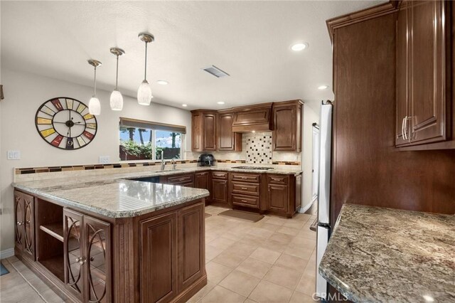 1412 Alta Mesa Way, Brea, CA 92821 - kitchen featuring tasteful backsplash, hanging light fixtures, light stone counters, custom exhaust hood, and a peninsula