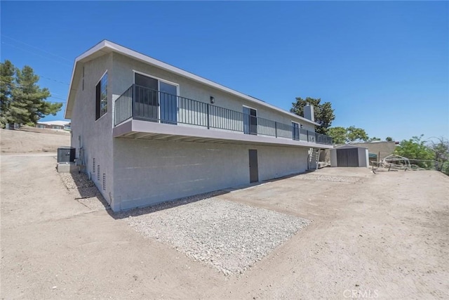 16739 Mission St, Hesperia, CA 92345 - rear view of property with a storage shed, cooling unit, an outdoor structure, and a balcony