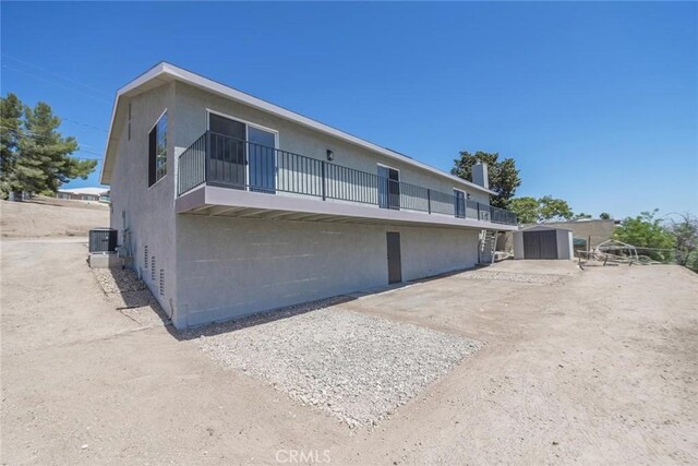16739 Mission St, Hesperia, CA 92345 - rear view of property with a storage shed and a balcony