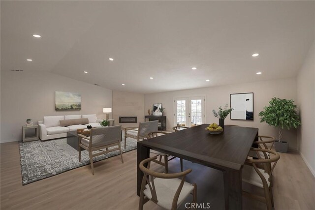 16739 Mission St, Hesperia, CA 92345 - dining room with light wood-style flooring, french doors, recessed lighting, baseboards, and a large fireplace