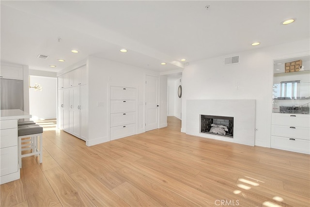 27 Burriana, San Clemente, CA 92672 - unfurnished living room with recessed lighting, light wood-style flooring, and a fireplace