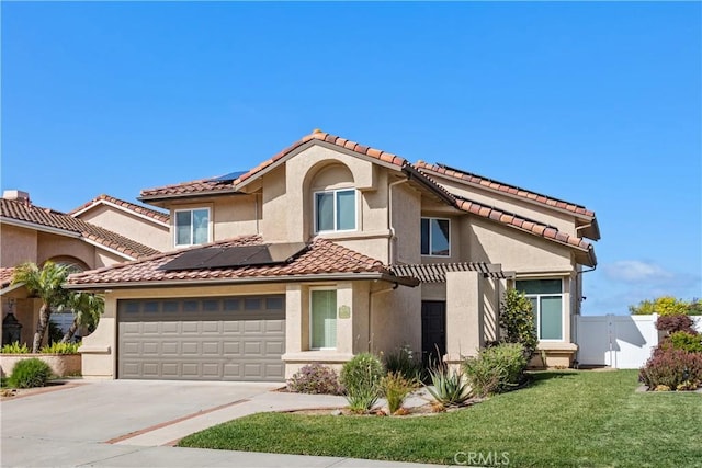 27 Burriana, San Clemente, CA 92672 - view of front of house featuring roof mounted solar panels, driveway, stucco siding, and a tile roof