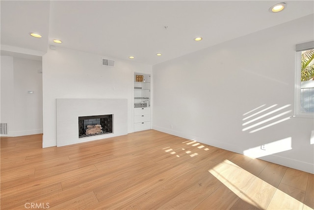 27 Burriana, San Clemente, CA 92672 - unfurnished living room with recessed lighting, light wood-style flooring, a fireplace, and baseboards
