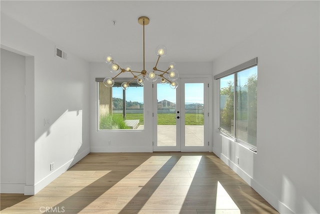 27 Burriana, San Clemente, CA 92672 - unfurnished dining area featuring wood finished floors, a chandelier, french doors, and baseboards