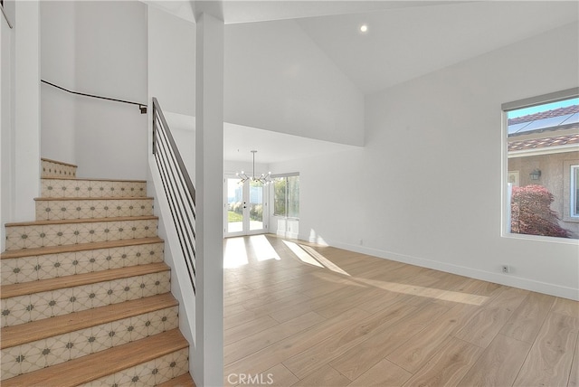 27 Burriana, San Clemente, CA 92672 - staircase with a chandelier, wood finished floors, high vaulted ceiling, baseboards, and recessed lighting