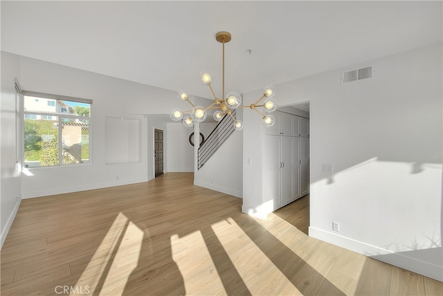 27 Burriana, San Clemente, CA 92672 - unfurnished dining area featuring a chandelier, baseboards, light wood-type flooring, and lofted ceiling
