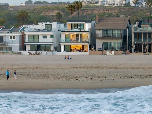 5007 Seashore Dr, Newport Beach, CA 92663 - rear view of property featuring stucco siding and view of water and beach