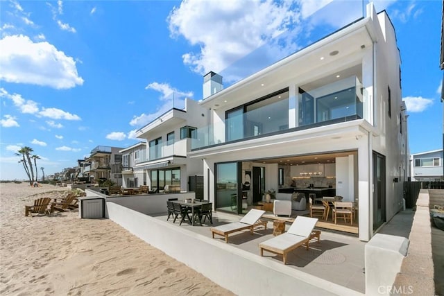 5007 Seashore Dr, Newport Beach, CA 92663 - rear view of property featuring a chimney and stucco siding