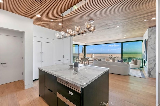 5007 Seashore Dr, Newport Beach, CA 92663 - kitchen with modern cabinets, a center island, light wood-style flooring, a chandelier, and hanging light fixtures