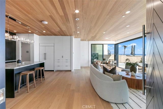 5007 Seashore Dr, Newport Beach, CA 92663 - living area featuring expansive windows, light wood finished floors, wooden ceiling, recessed lighting, and a chandelier