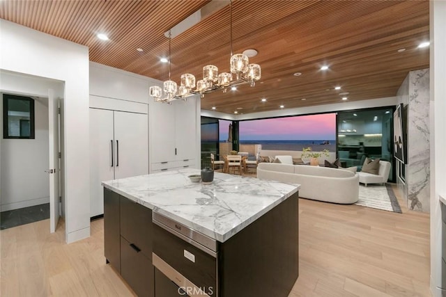 5007 Seashore Dr, Newport Beach, CA 92663 - kitchen featuring a kitchen island, modern cabinets, light wood finished floors, a chandelier, and decorative light fixtures