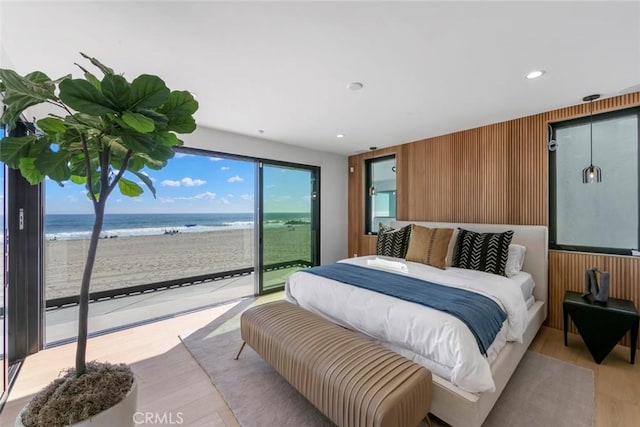 5007 Seashore Dr, Newport Beach, CA 92663 - bedroom featuring access to exterior, view of water and beach, light wood finished floors, wood walls, and recessed lighting