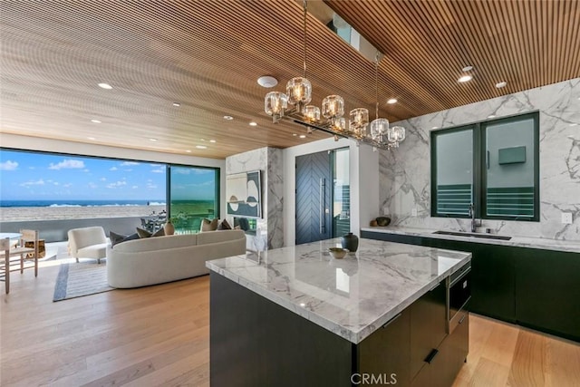 5007 Seashore Dr, Newport Beach, CA 92663 - kitchen with a sink, a chandelier, a kitchen island, pendant lighting, and open floor plan