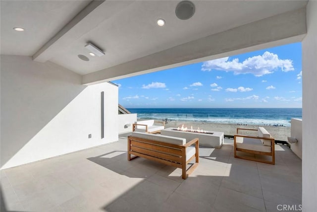5007 Seashore Dr, Newport Beach, CA 92663 - view of patio with view of water and beach and an outdoor living space with a fire pit