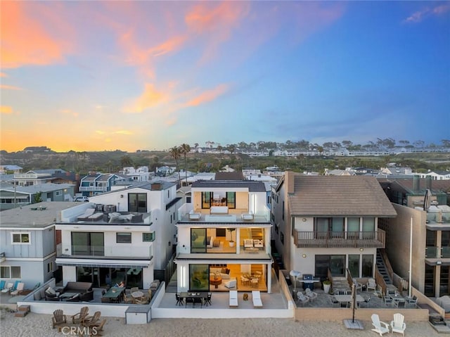5007 Seashore Dr, Newport Beach, CA 92663 - back of house at dusk featuring a residential view and stucco siding