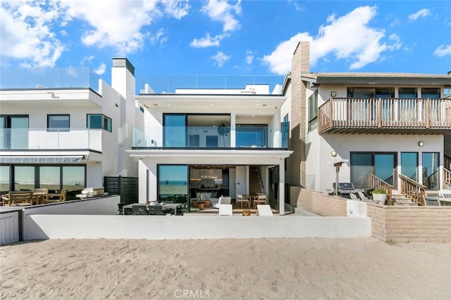5007 Seashore Dr, Newport Beach, CA 92663 - rear view of property featuring a chimney, stucco siding, and a balcony
