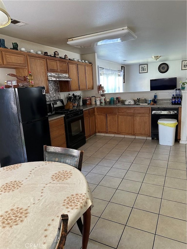 336 Pyramid Ave, Merced, CA 95341 - kitchen with black appliances, light tile patterned flooring, brown cabinets, ventilation hood, and a sink