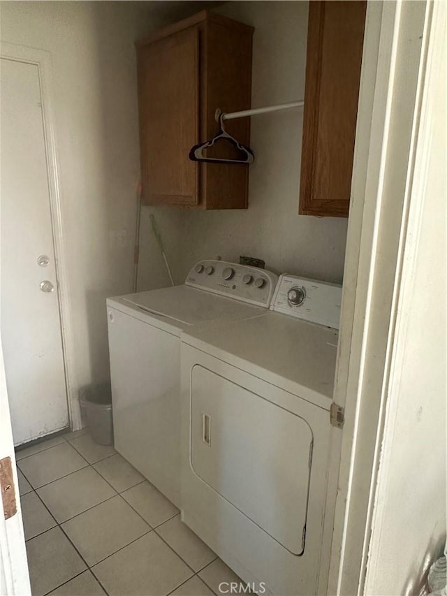 336 Pyramid Ave, Merced, CA 95341 - laundry room featuring independent washer and dryer, cabinet space, and light tile patterned floors