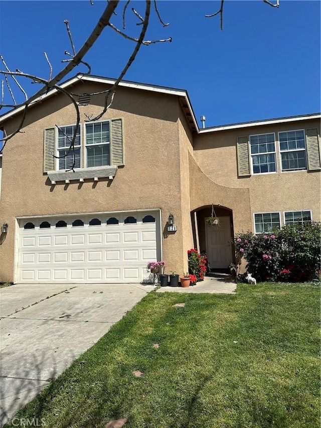 336 Pyramid Ave, Merced, CA 95341 - traditional-style house featuring stucco siding, an attached garage, concrete driveway, and a front yard