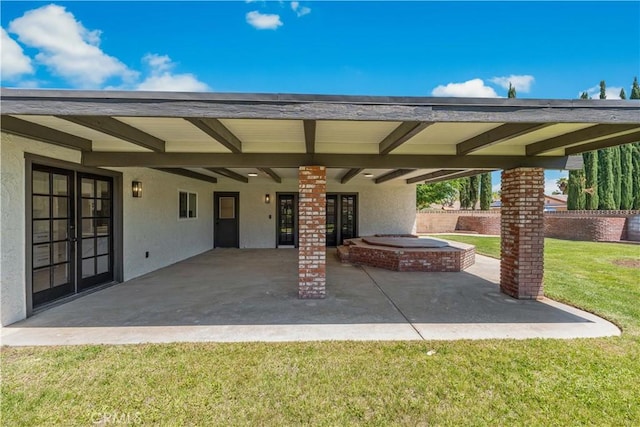 view of patio / terrace with french doors and an outdoor hot tub