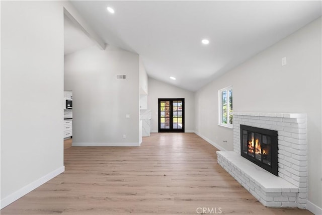 unfurnished living room featuring a brick fireplace, light wood-style flooring, baseboards, and recessed lighting