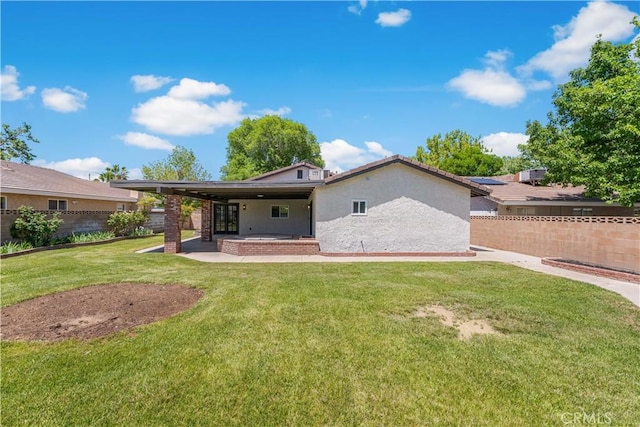 back of property with stucco siding and a patio area