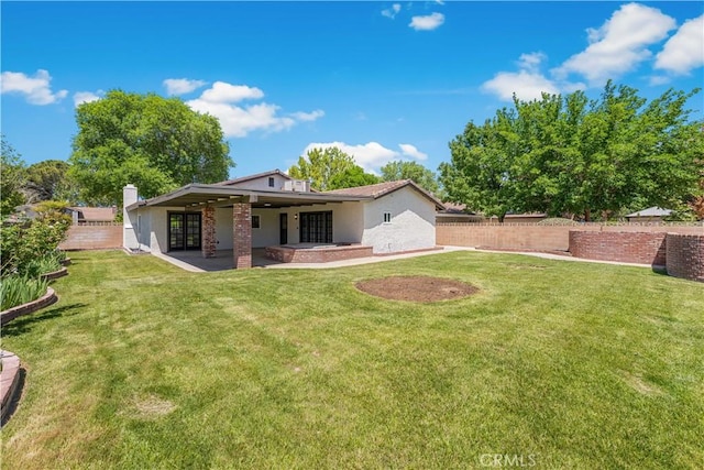 back of property featuring french doors, a patio area, and stucco siding