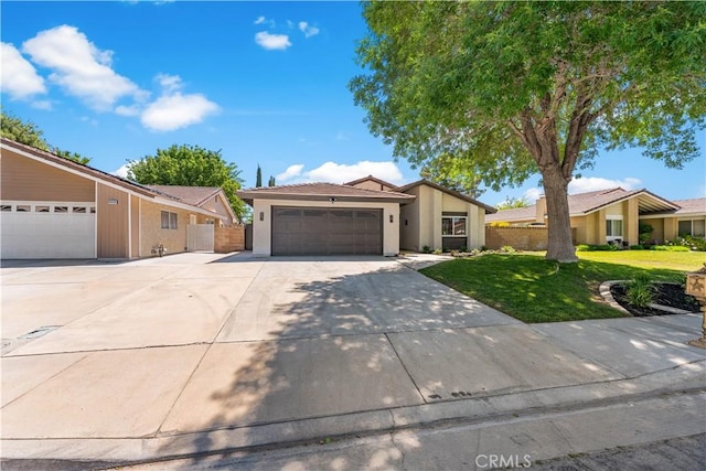 view of front of home with a garage, concrete driveway, and stucco siding