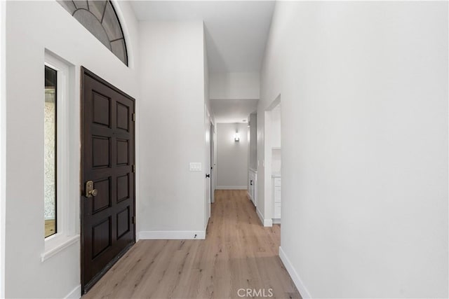entrance foyer with light wood-style flooring and baseboards