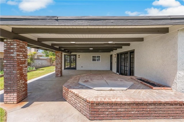 view of patio / terrace featuring fence and french doors