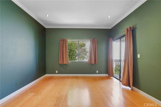 2101 E 21st St Unit 310, Signal Hill, CA 90755 - empty room featuring healthy amount of natural light, light wood-style floors, crown molding, and baseboards