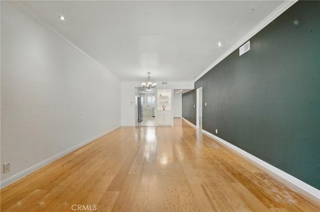 2101 E 21st St Unit 310, Signal Hill, CA 90755 - unfurnished living room featuring a chandelier, ornamental molding, light wood-style flooring, and baseboards
